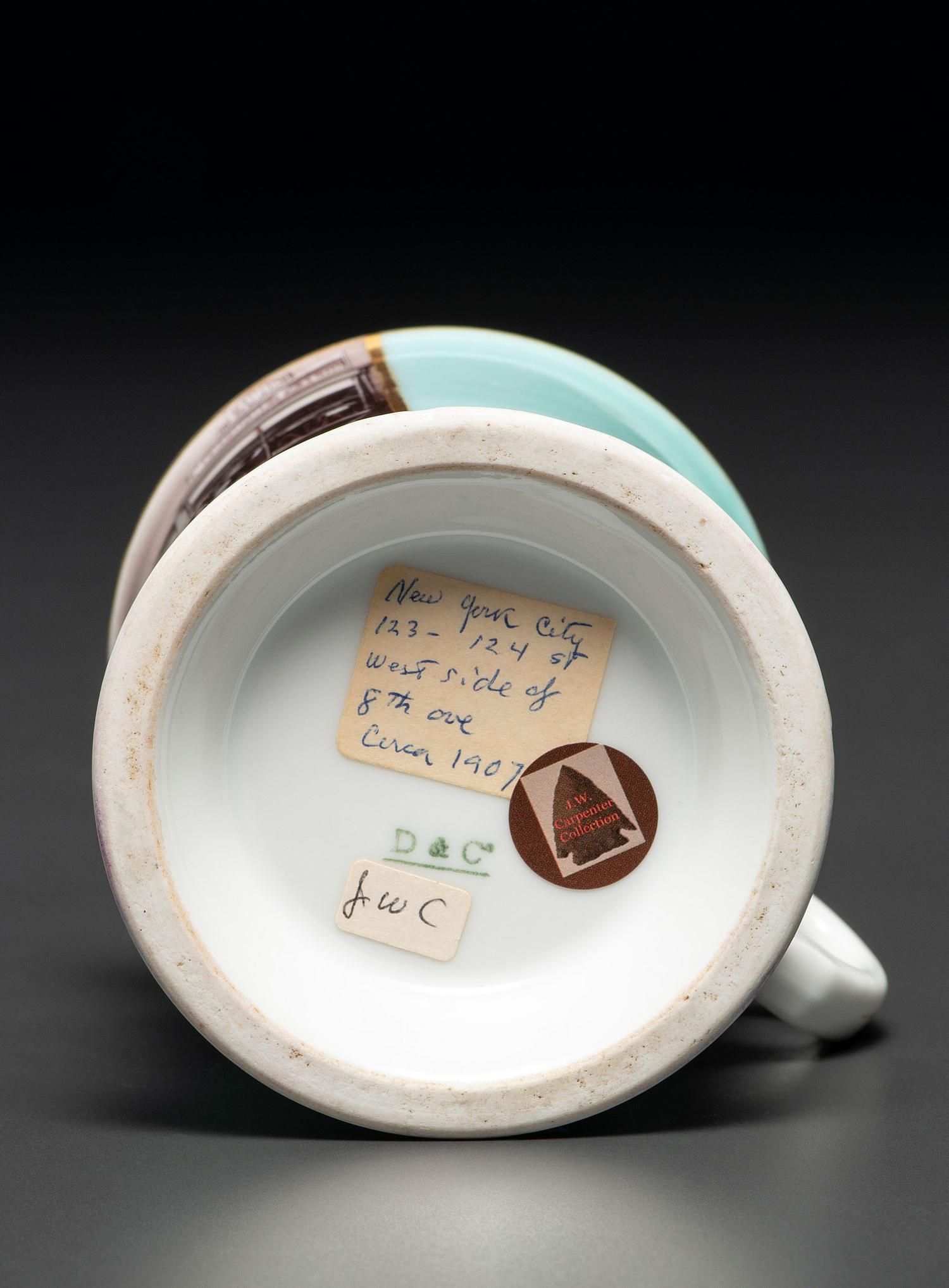 A Paint Enhanced Photographic Transfer Porcelain Occupational Shaving Mug Depicting a Tailor's Shop