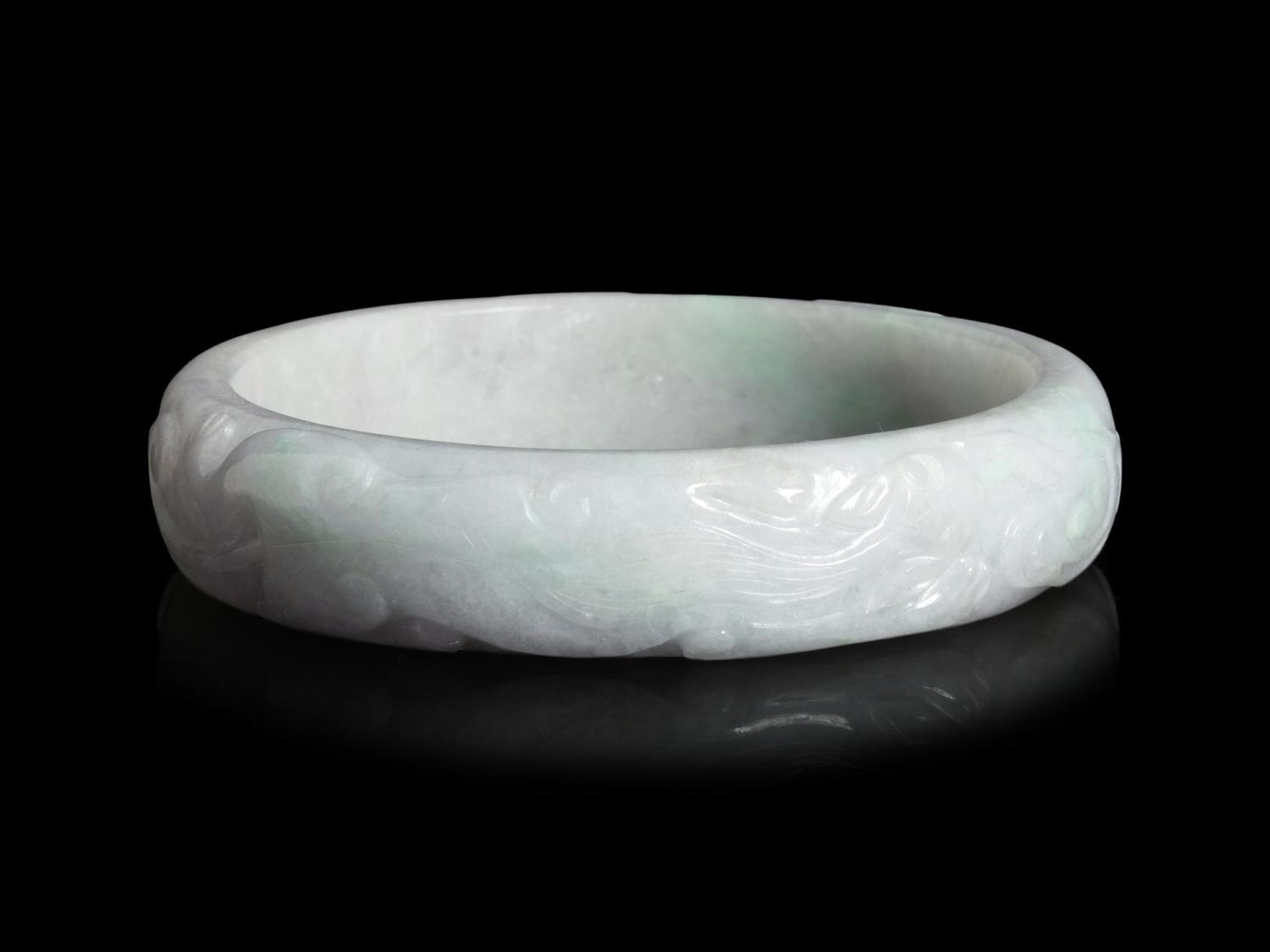 A Large Chinese Carved Jadeite Bangle