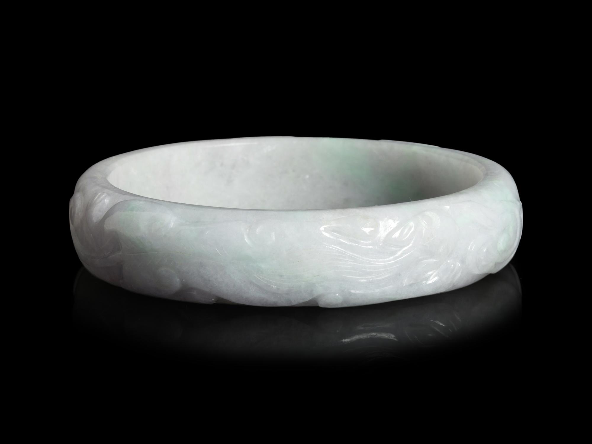 A Large Chinese Carved Jadeite Bangle