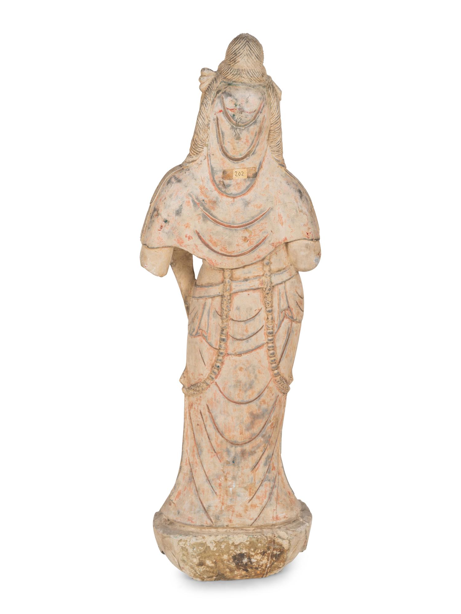 A Chinese Carved Stone Standing Guanyin Figure with Remnants of Polychrome Decoration