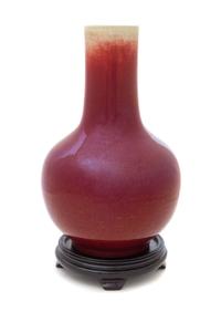 A Sang-de-Boeuf Glazed Porcelain Bottle Vase Height 12 1/2 inches. — MID-19TH CENTURY
