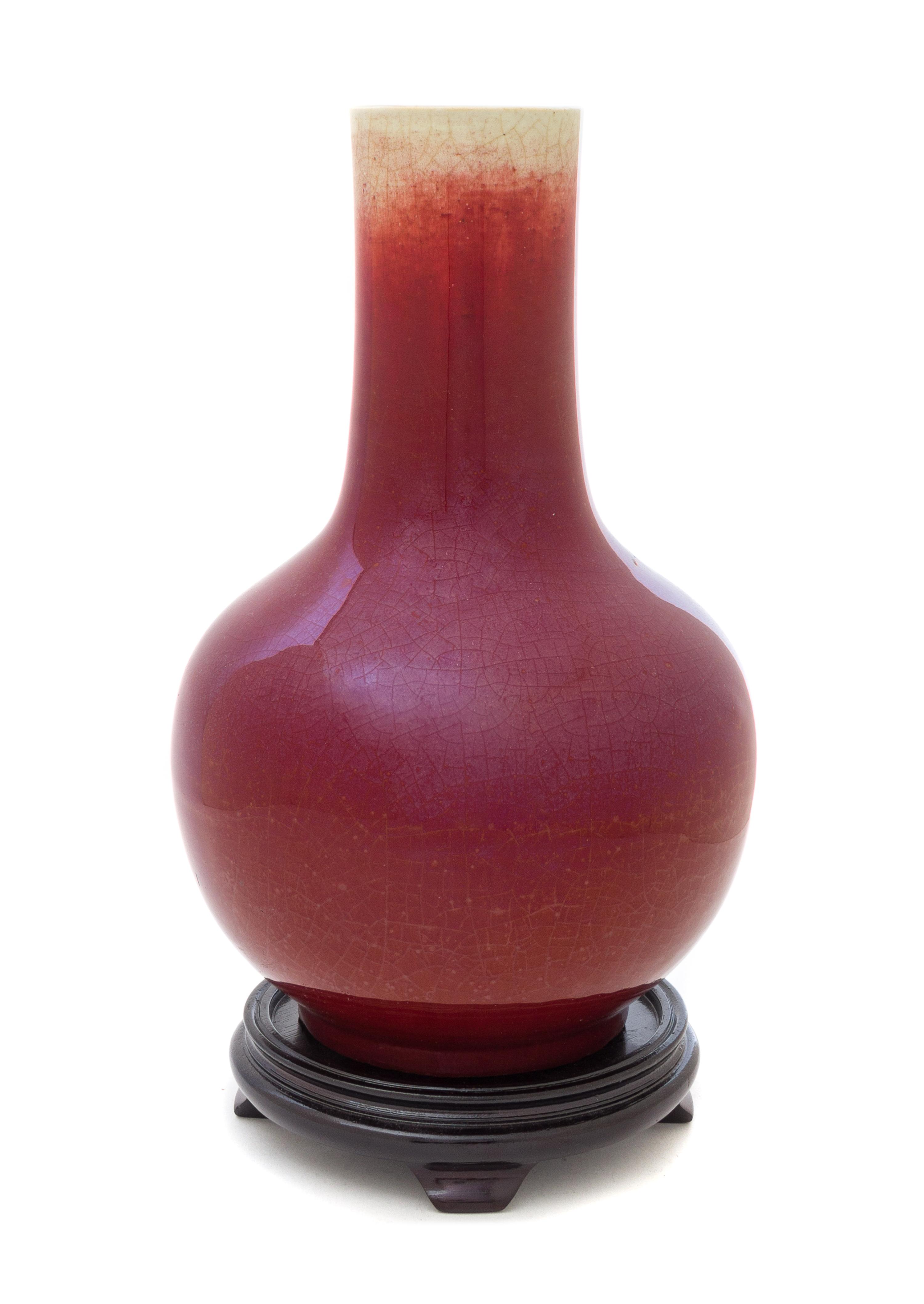 A Sang-de-Boeuf Glazed Porcelain Bottle Vase Height 12 1/2 inches. — MID-19TH CENTURY