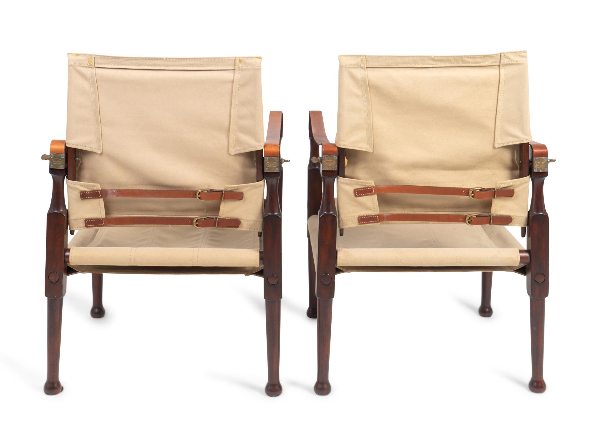 A Pair of British Colonial Style Mahogany, Canvas and Leather Strap Campaign Chairs — 20TH CENTURY