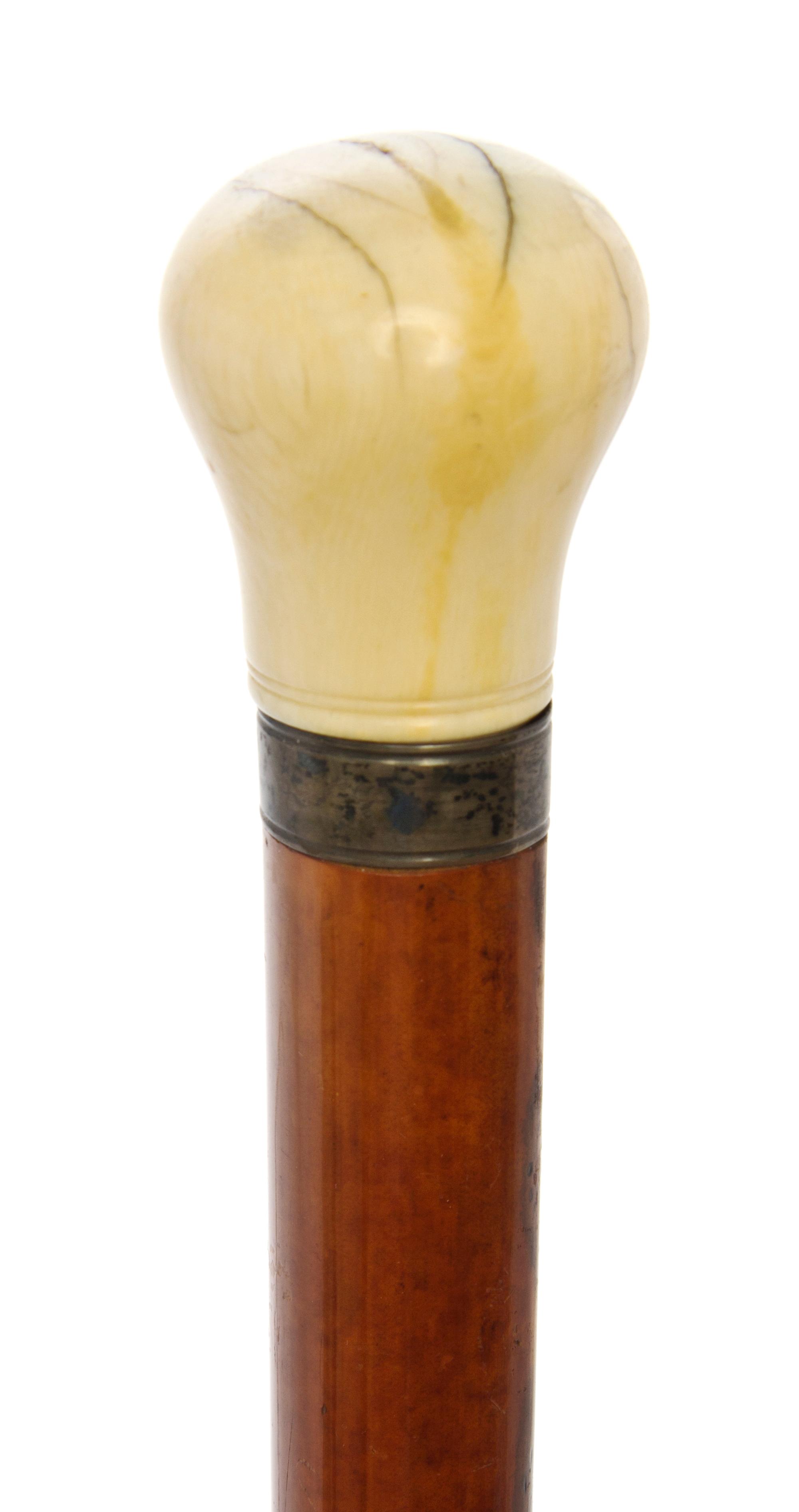 An English Ivory Handled Walking Stick, Length of handle 2 1/8 x length overall 45 1/4 inches.