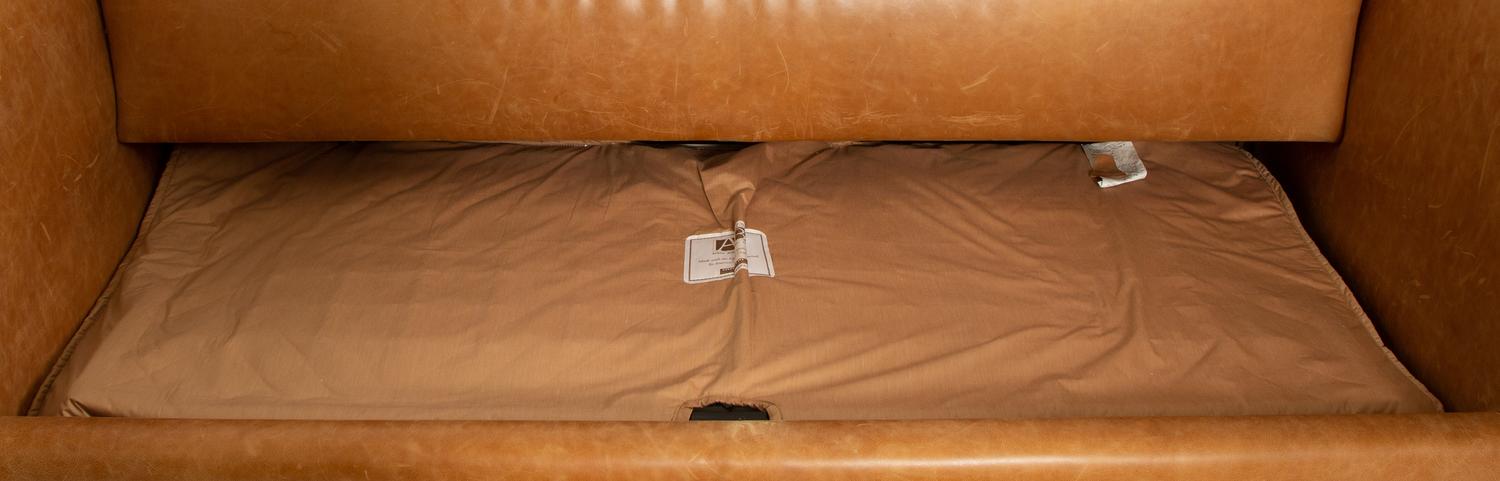 A Contemporary Leather Sofa with Two Bolster Pillows