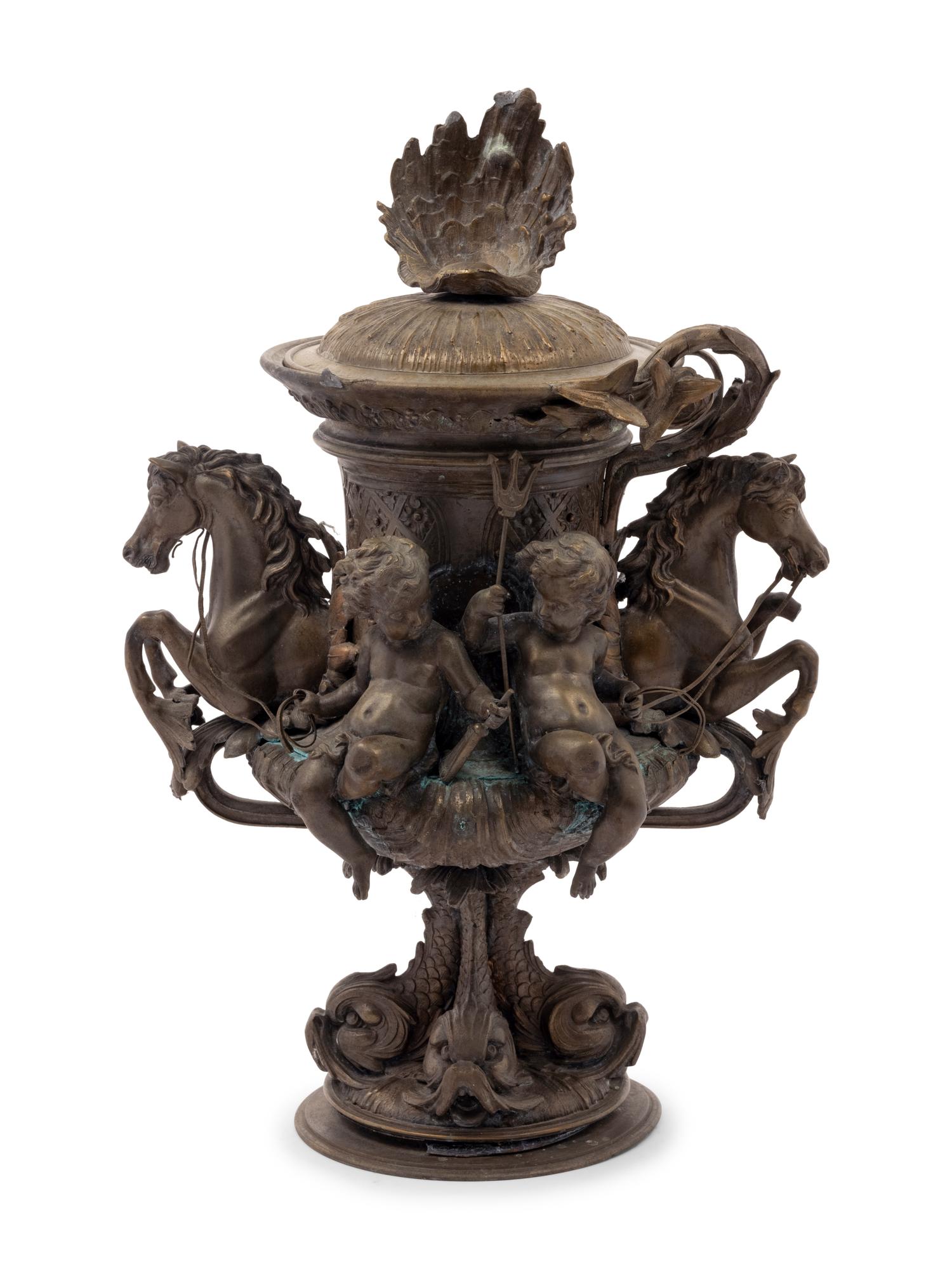 A Continental Cast Metal Urn with Putti and Hippocampi