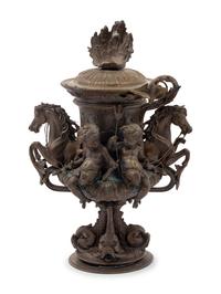A Continental Cast Metal Urn with Putti and Hippocampi