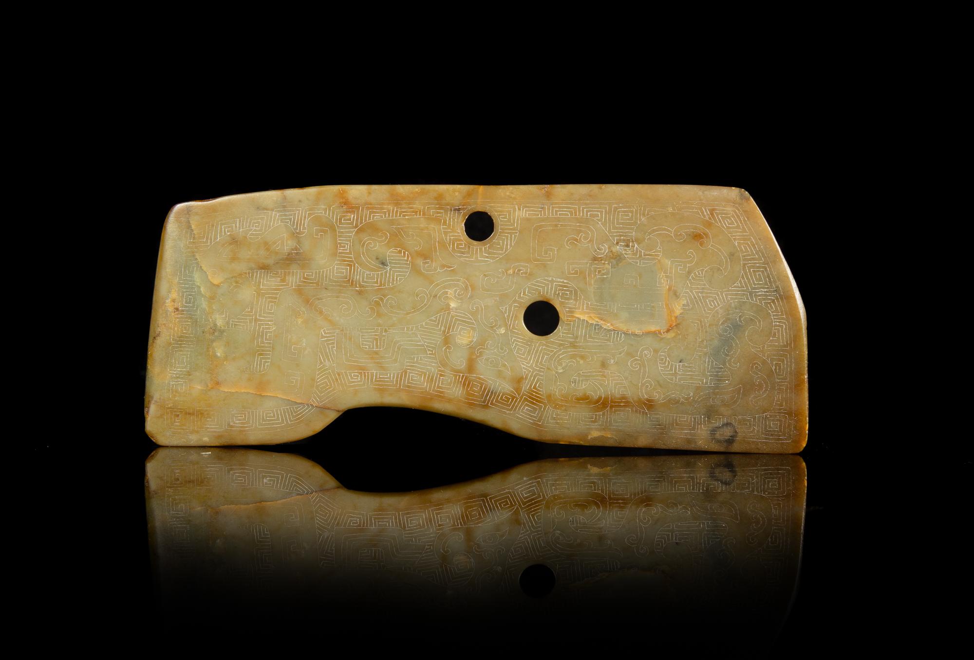 A Russet and Celadon Jade Blade