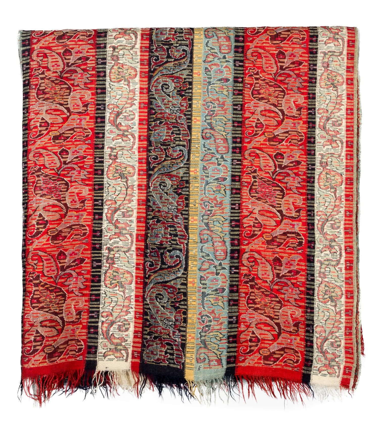 A Group of Pillows and Two Paisley Coverlets Larger paisley 10 feet 11 inches x 5 feet 4 inches.
