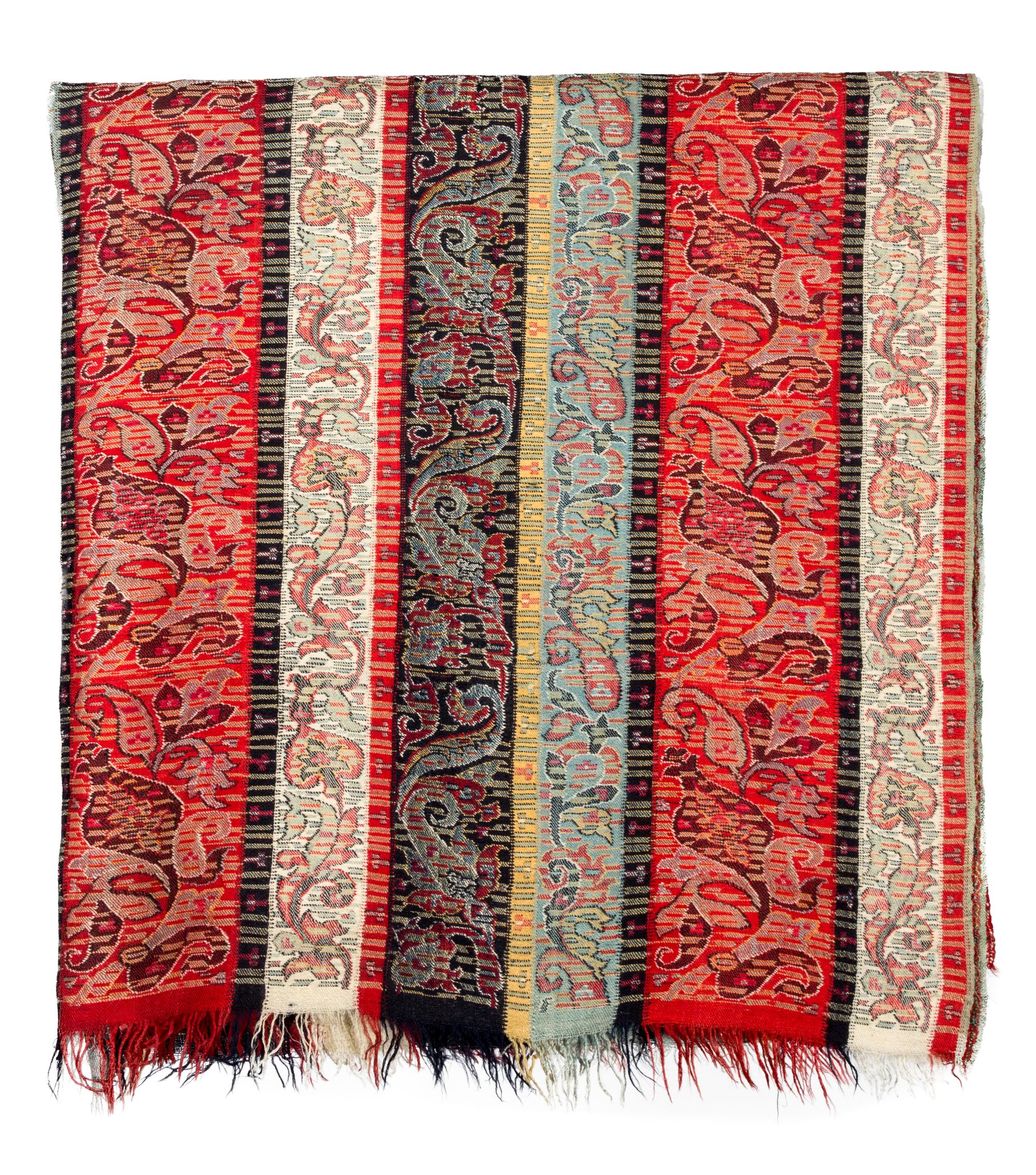 A Group of Pillows and Two Paisley Coverlets Larger paisley 10 feet 11 inches x 5 feet 4 inches.