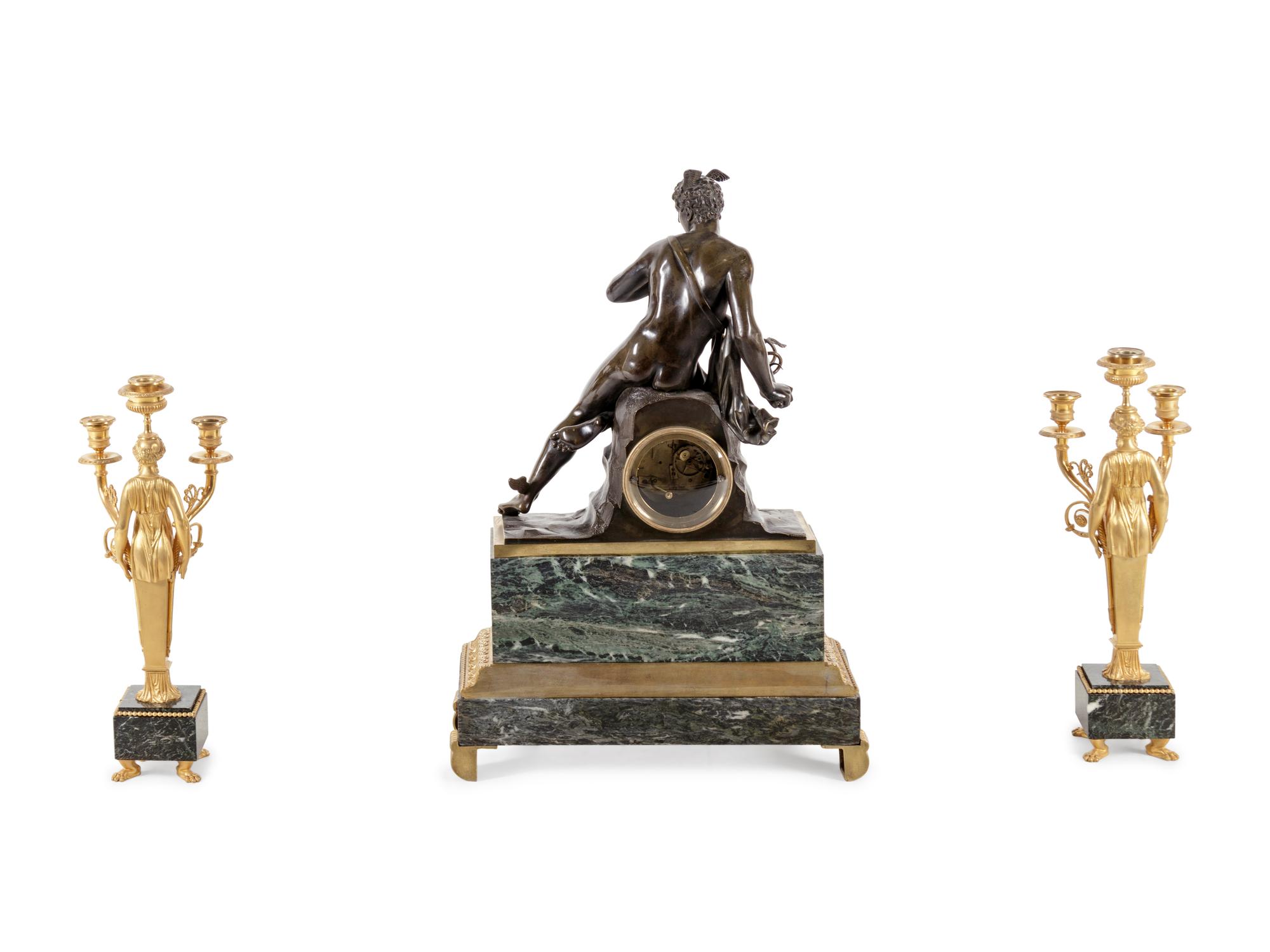 An Empire Style Gilt and Patinated Bronze and Marble Clock Garniture