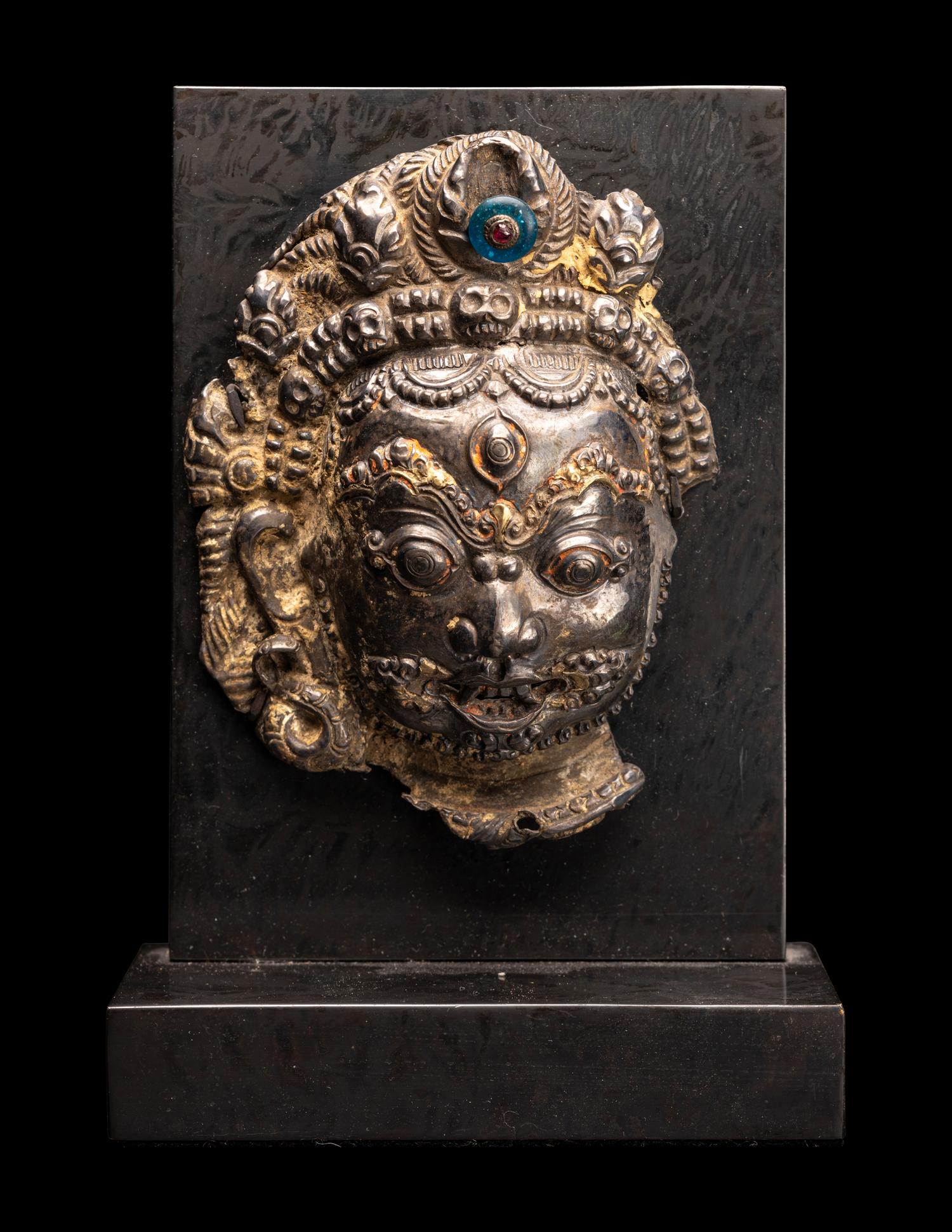 A Nepalese Silvered Metal Repouss é Mask of Bhairava