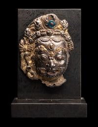 A Nepalese Silvered Metal Repouss é Mask of Bhairava