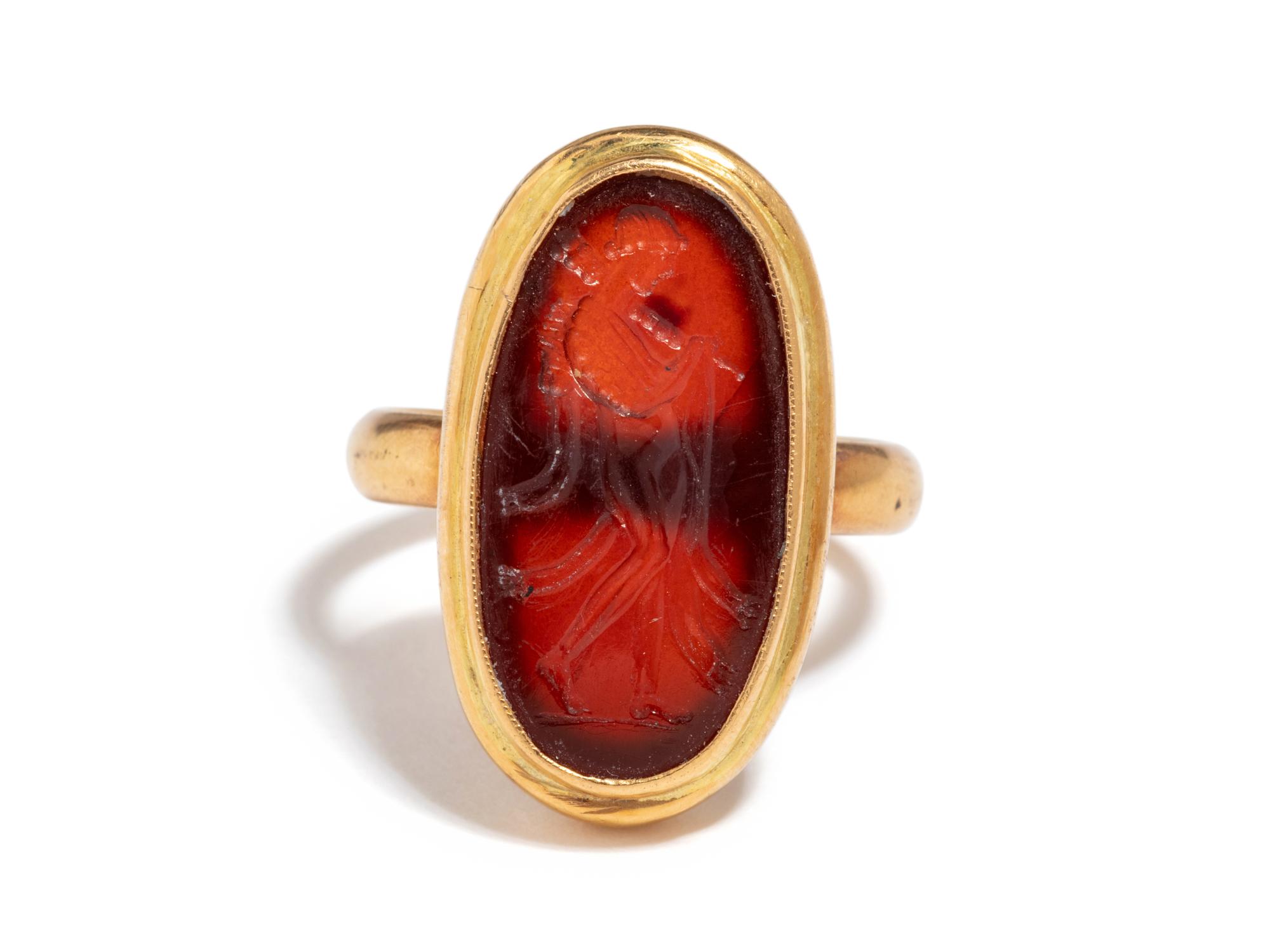 A Roman Carnelian Ring Stone with the Queen Omphale Dressed as Hercules — Set in a gold ring