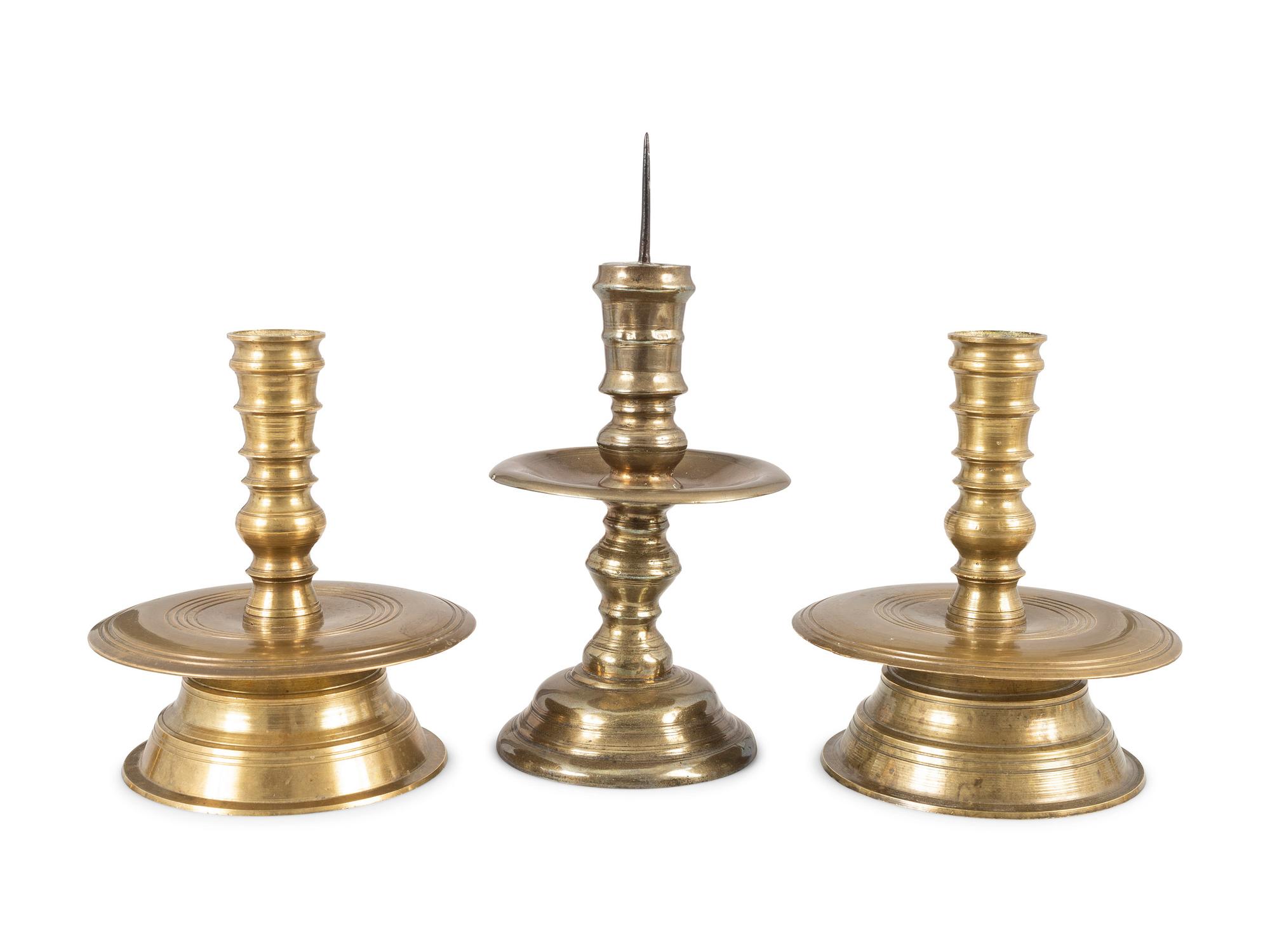 Three Continental Cast Brass Heemskirk Candlesticks
