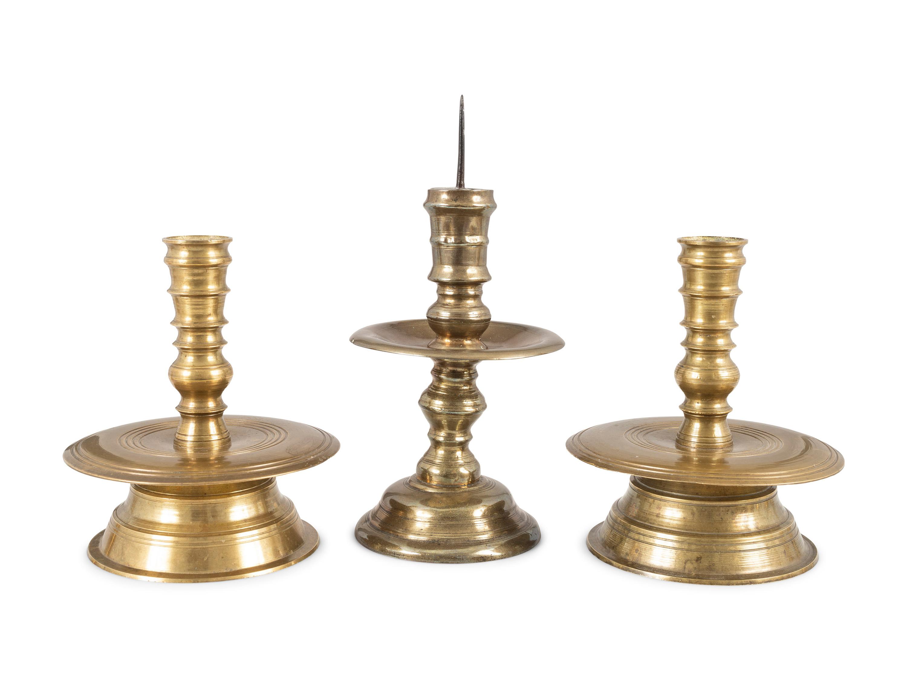 Three Continental Cast Brass Heemskirk Candlesticks