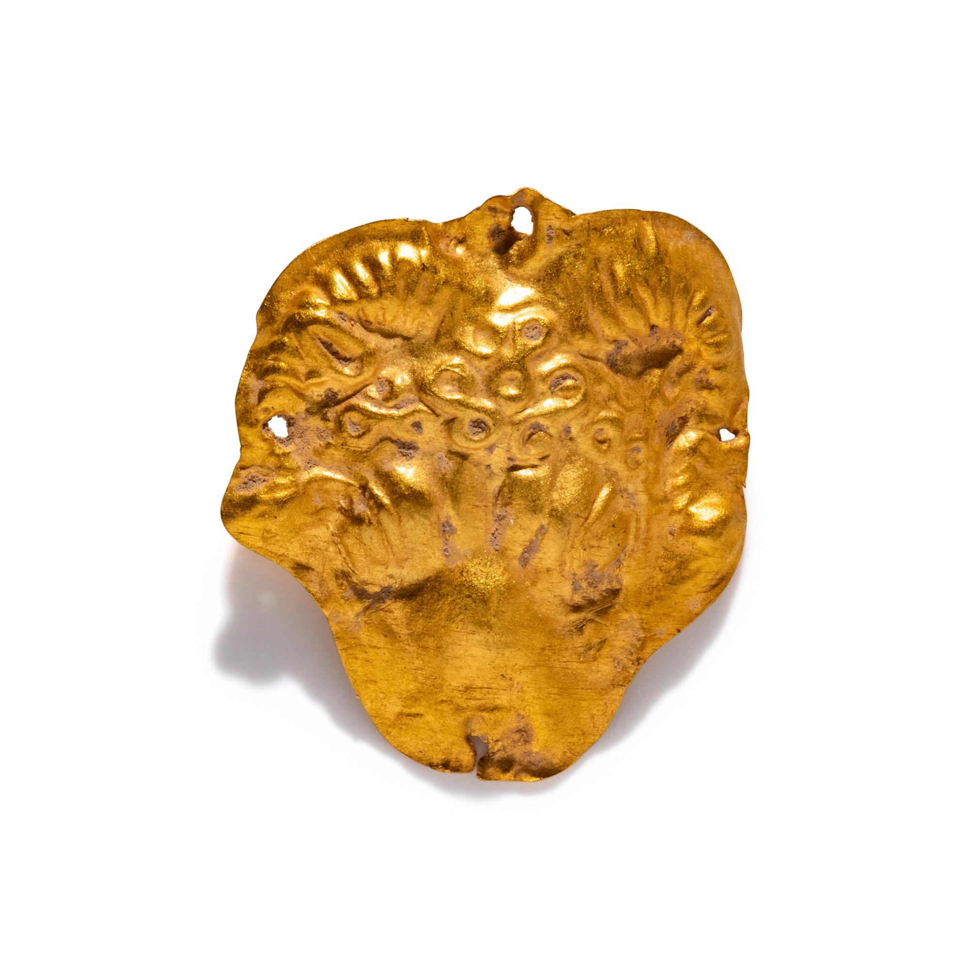 A Near Eastern Gold Ram's Head Applique
