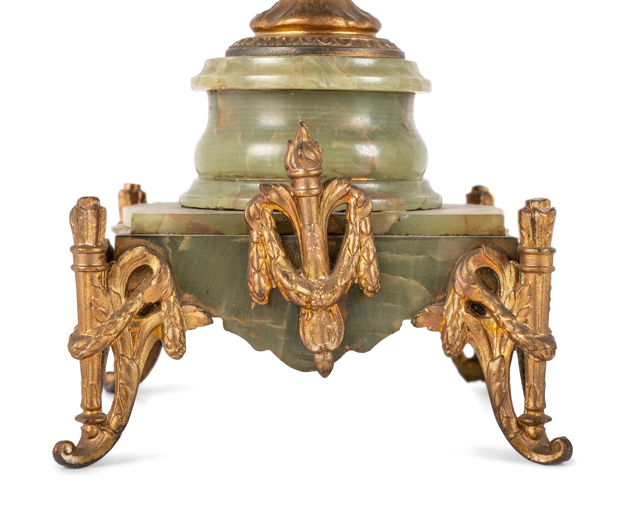 A French Metal and Onyx Clock Garniture with Figure after Francois Moreau (French, 1832-1927)