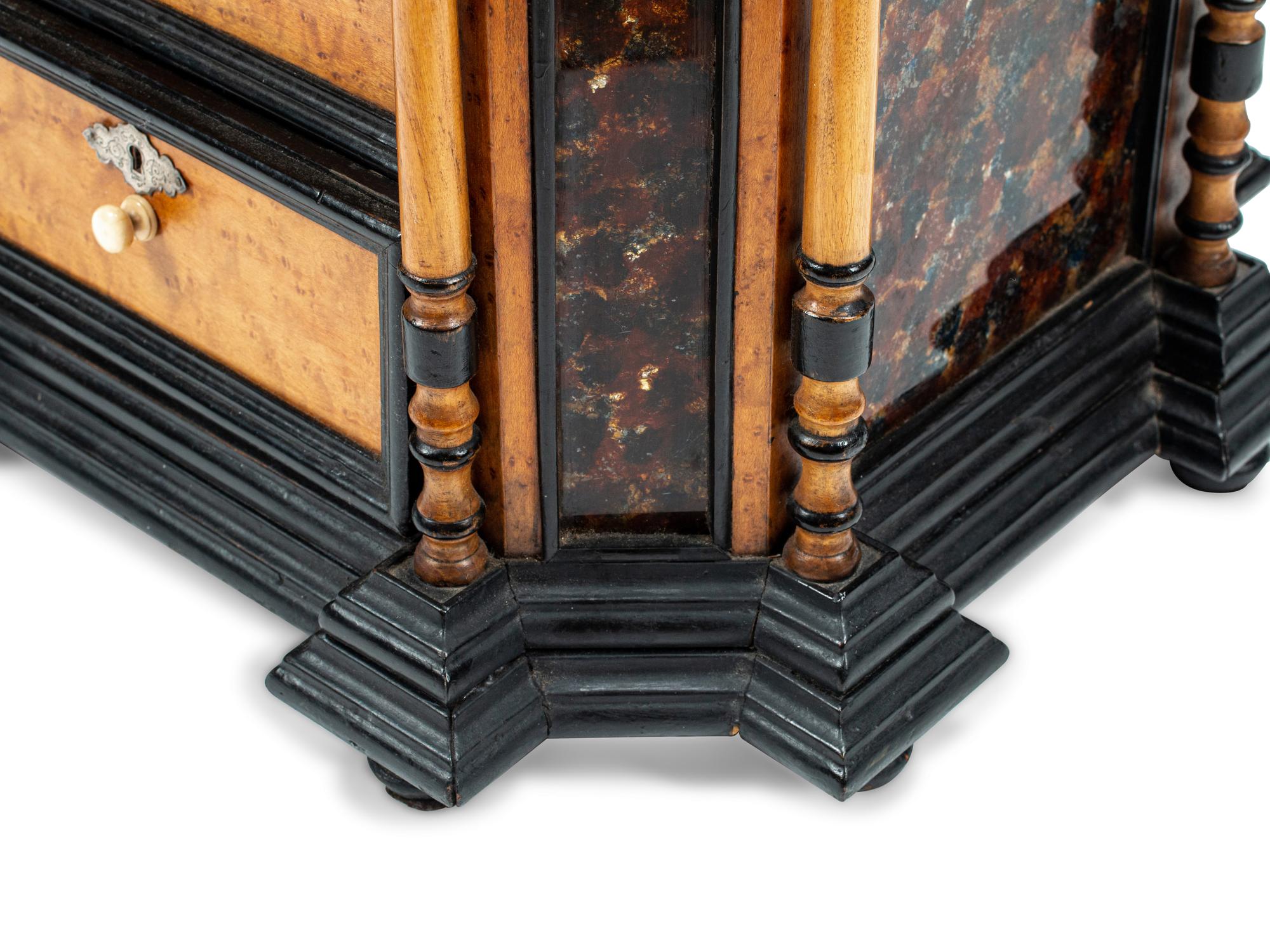 A Continental Birdseye Maple, Ebonized Wood and Painted Foil Table Cabinet