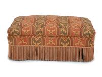An Upholstered Button Tufted Ottoman with Skirt