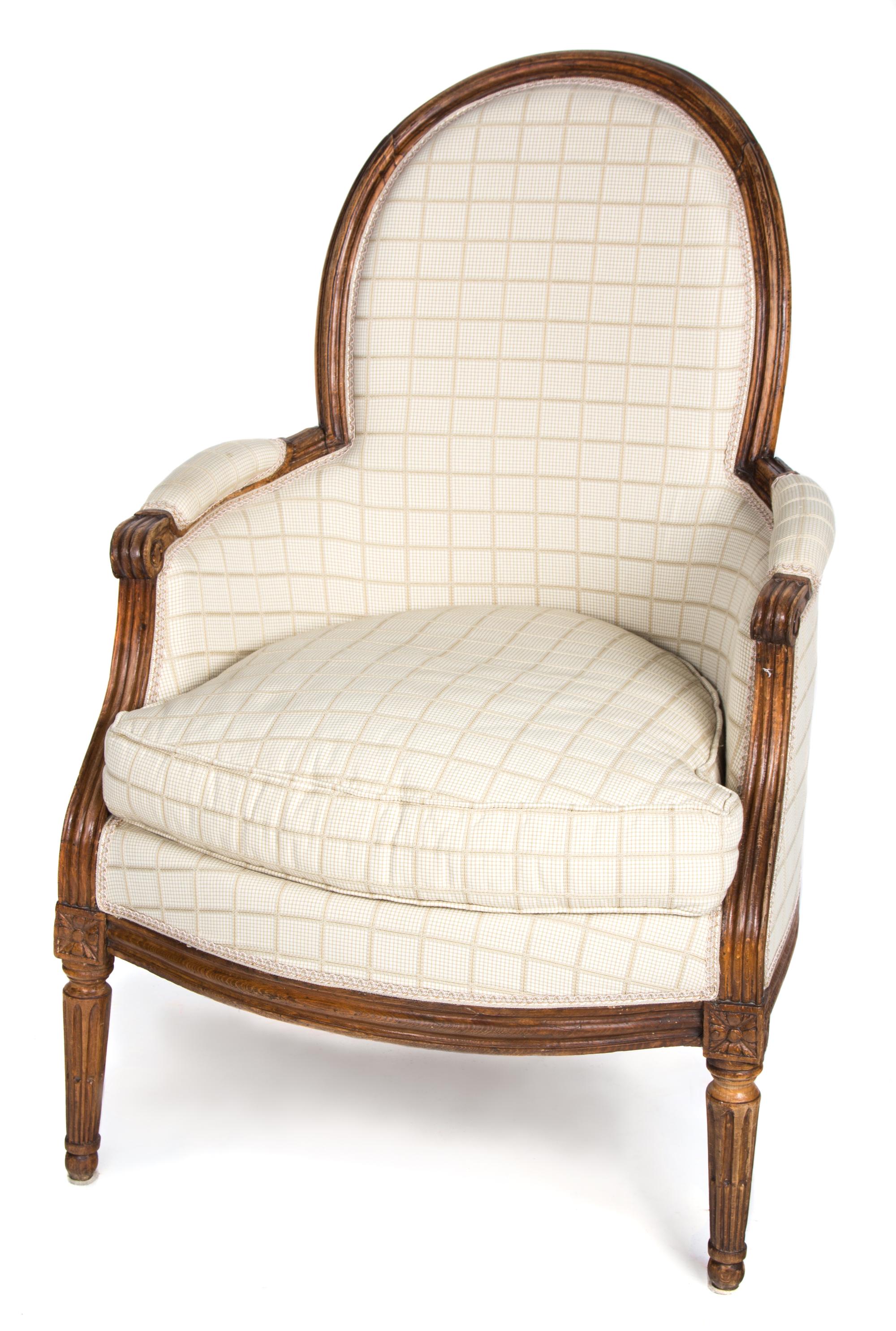 A Louis XVI Carved Walnut Bergere Height 37 inches. — LATE 18TH CENTURY