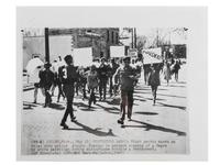 [CIVIL RIGHTS]. Press photograph of African American youths marching on the Niles, MI, police station to protest the slaying of an African American by a white patrolman during a disturbance. Niles, MI, 27 May 1969.