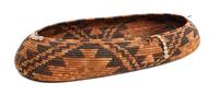 A Large Pomo Oval Gift Basket Height 2 3/4 x length 21 x width 9 inches.