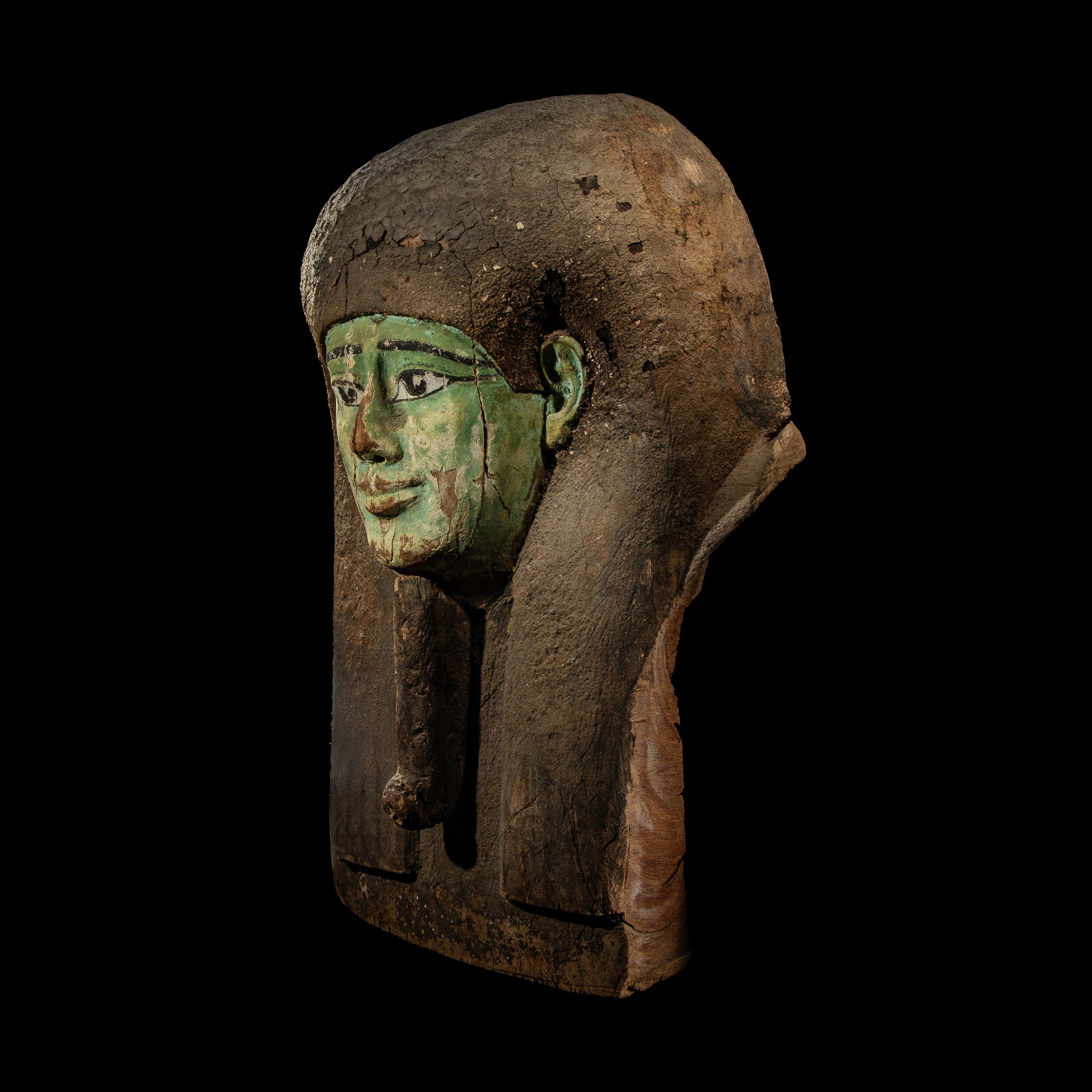An Egyptian Painted Wood Sarcophagus Head