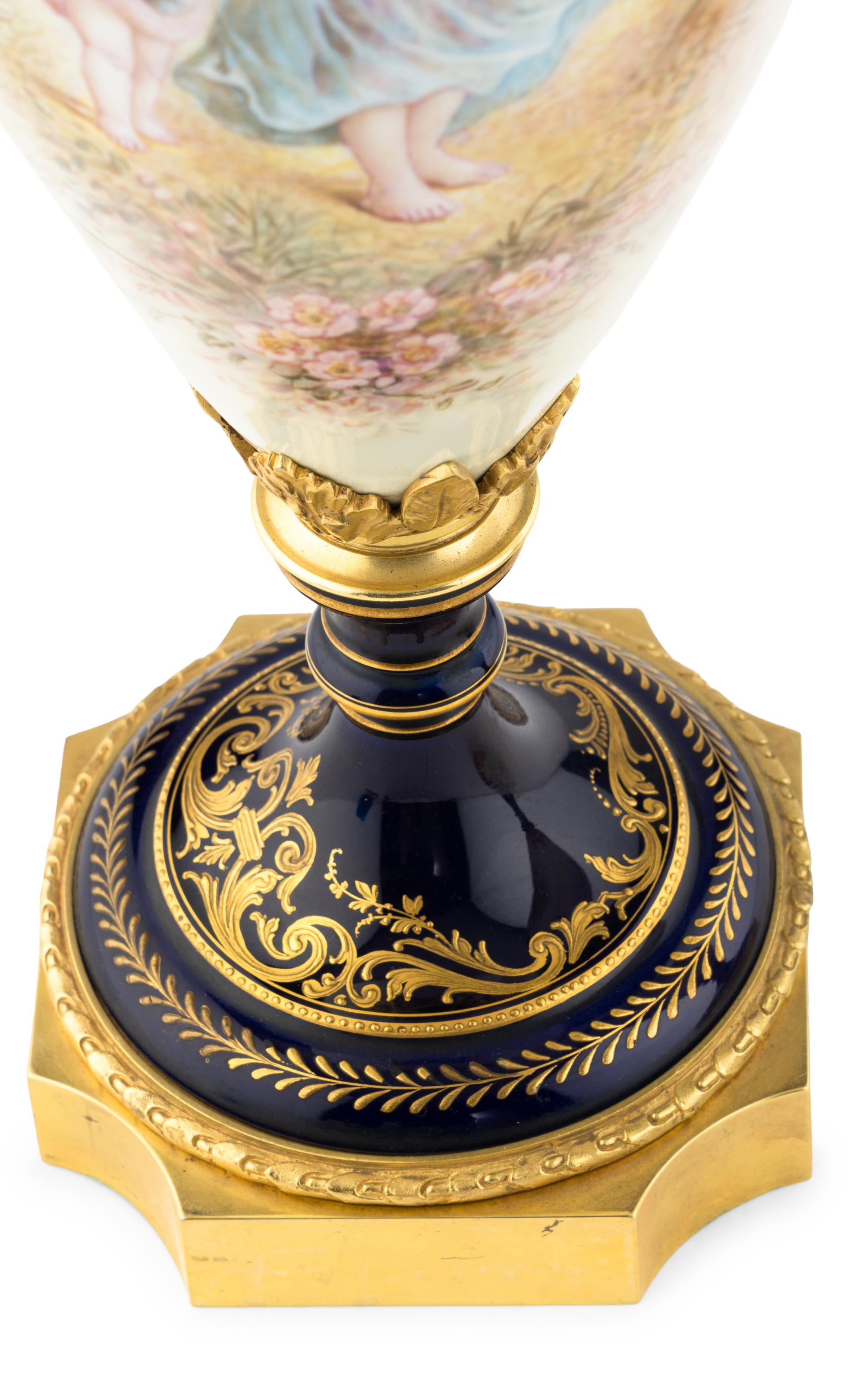 A Pair of Gilt Bronze Mounted Sèvres Style Porcelain Urns