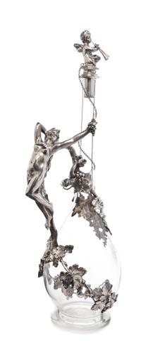 A German Silver Mounted Cut Glass Decanter, Bruckmann & Sohne, Heilbronn, Circa 1910, having a figural stopper in the form of winged pu