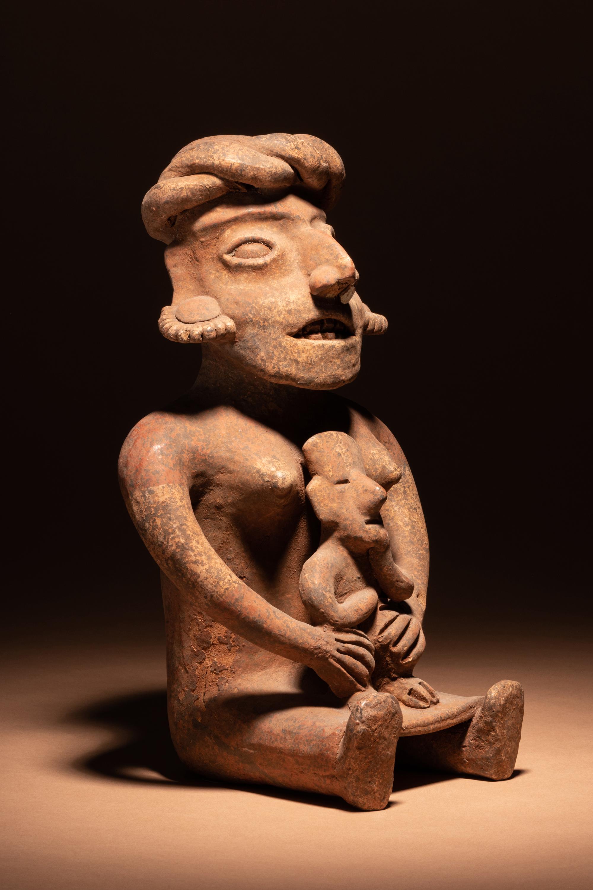 A Colima Terracotta Seated Mother and Child Figure
