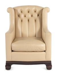 A Faux Leather Upholstered Lounge Chair and Ottoman