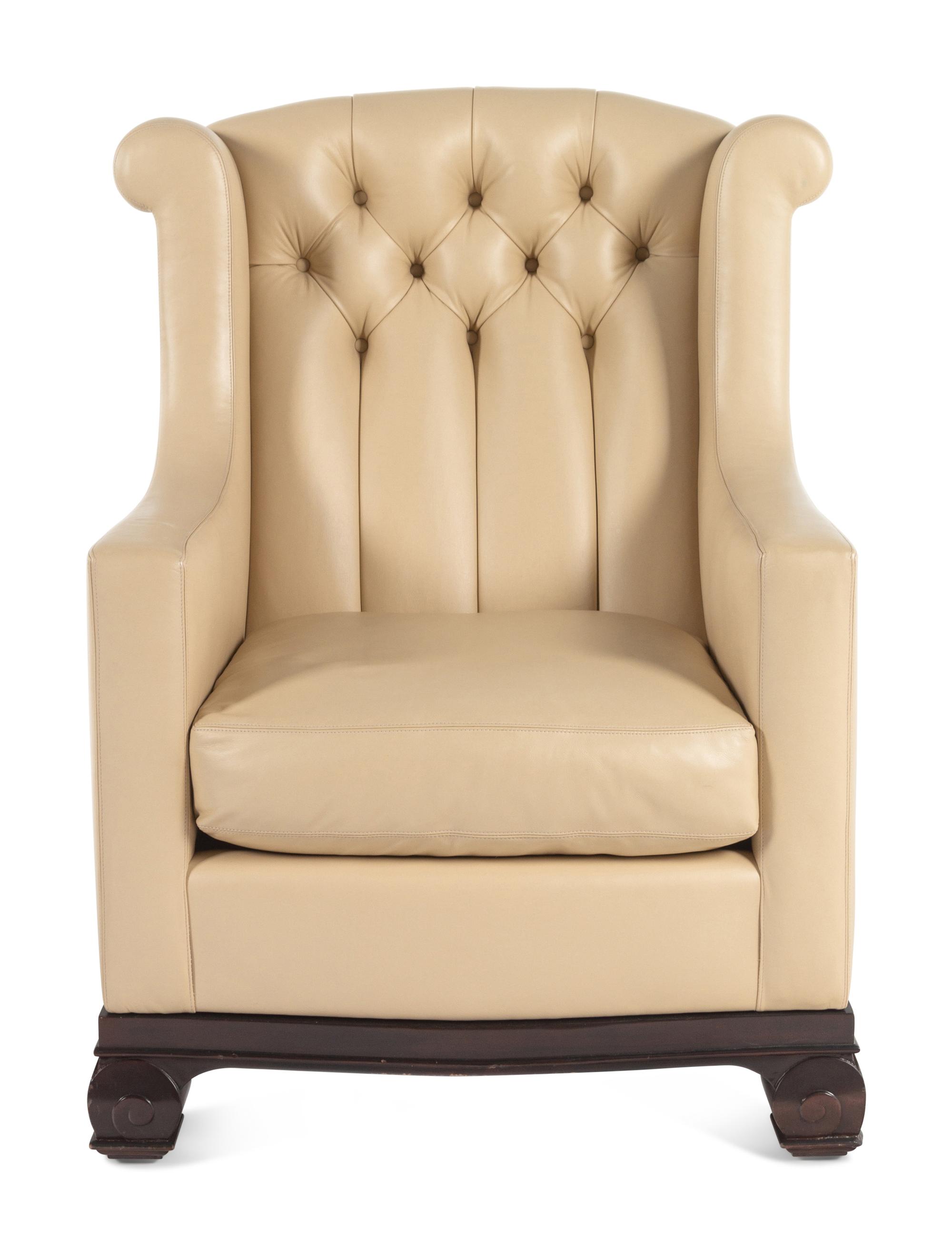 A Faux Leather Upholstered Lounge Chair and Ottoman