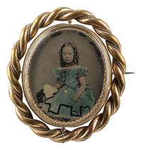 [EARLY PHOTOGRAPHY]. Large swivel cameo brooch featuring a hand-tinted ambrotype portrait of a young girl.