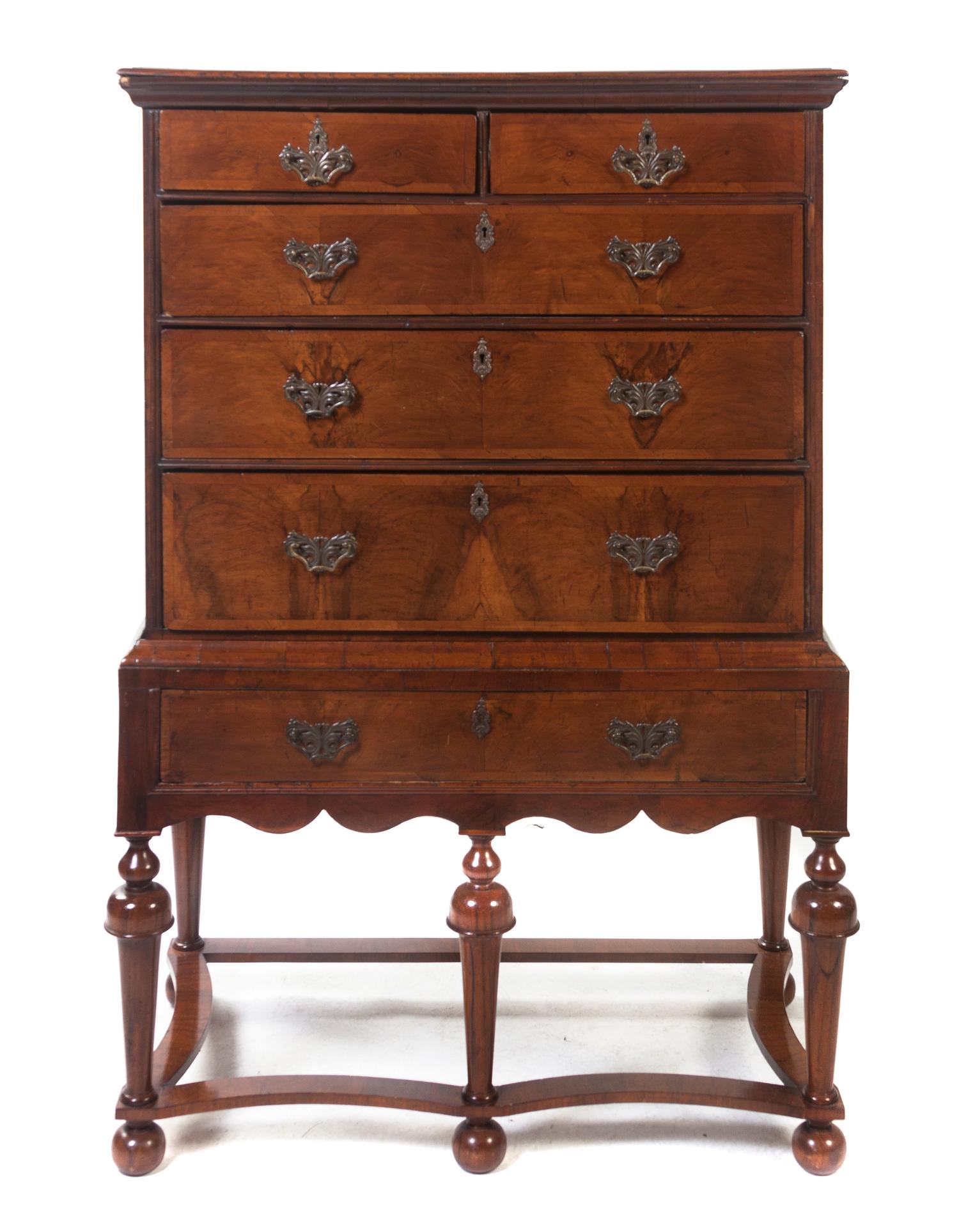 A William & Mary Style Walnut Chest on Stand, Height 58 x width 38 1/4 x depth 20 1/2 inches.