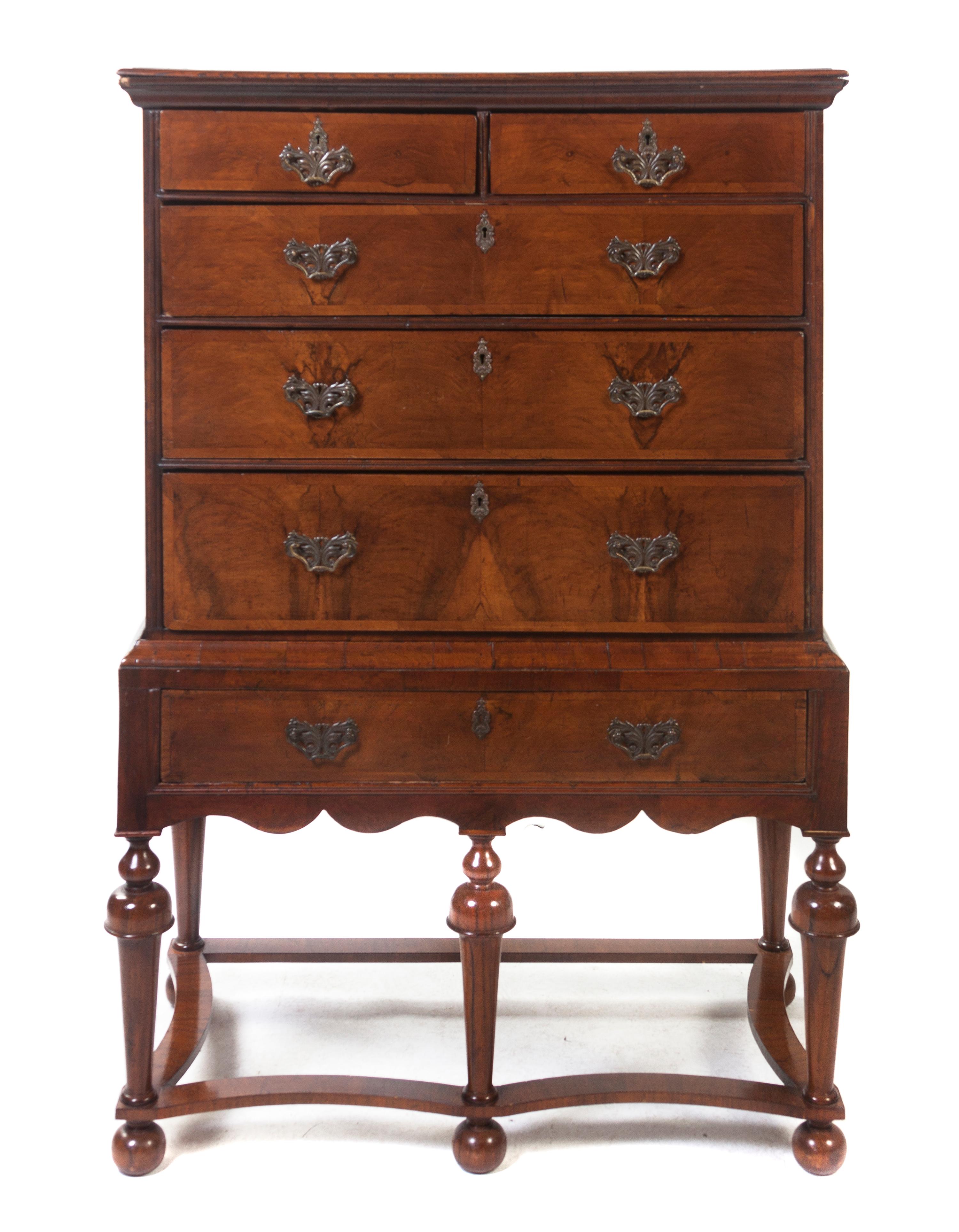 A William & Mary Style Walnut Chest on Stand, Height 58 x width 38 1/4 x depth 20 1/2 inches.