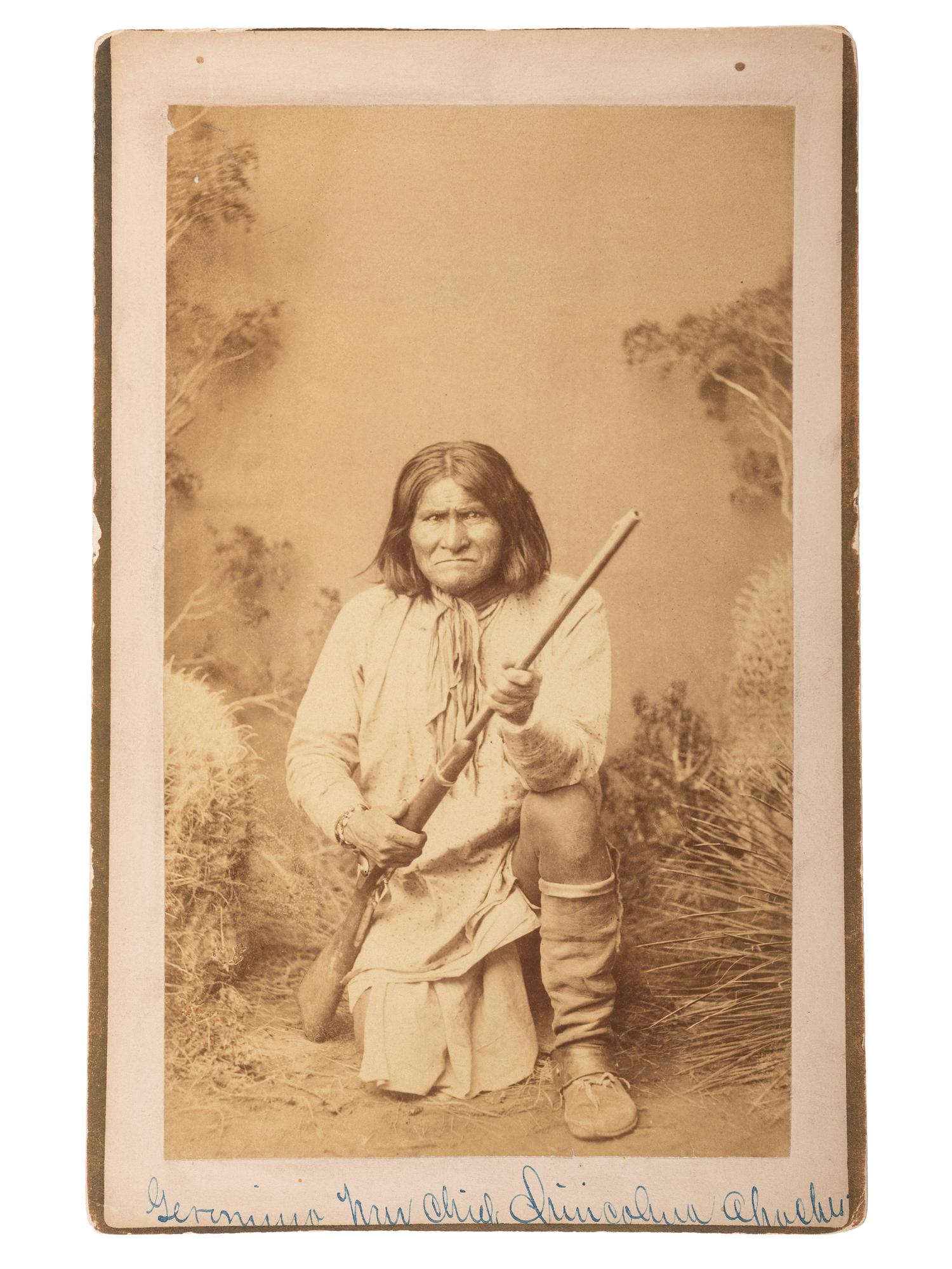 [NATIVE AMERICANS]. RANDALL, A. Frank, photographer. Boudoir card of Geronimo kneeling, holding an 1873 Springfield carbine rifle. Wilcox, Arizona Territory: 1885.