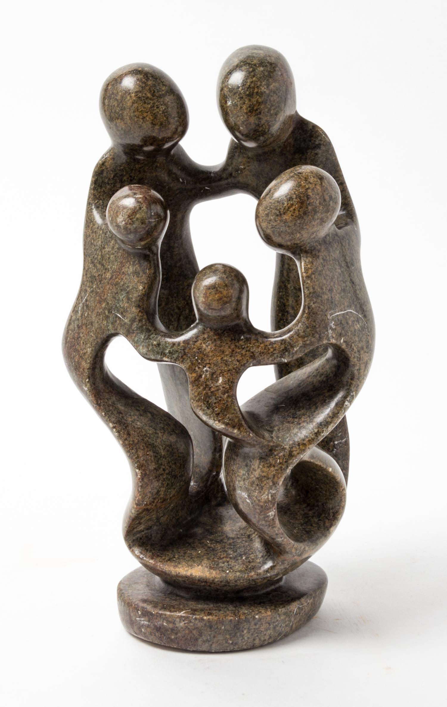 A Carved Stone Figural Group Height 10 inches.