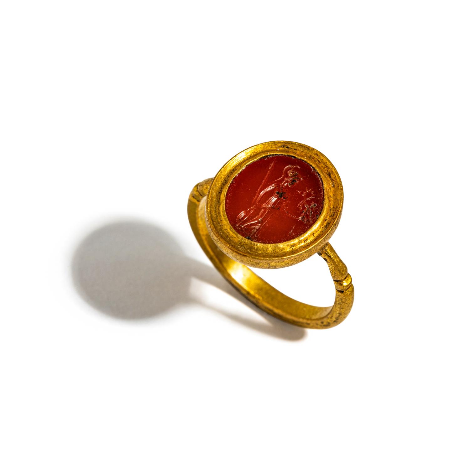 A Roman Gold and Carnelian Finger Ring with the Goddess Minerva Holding Nike