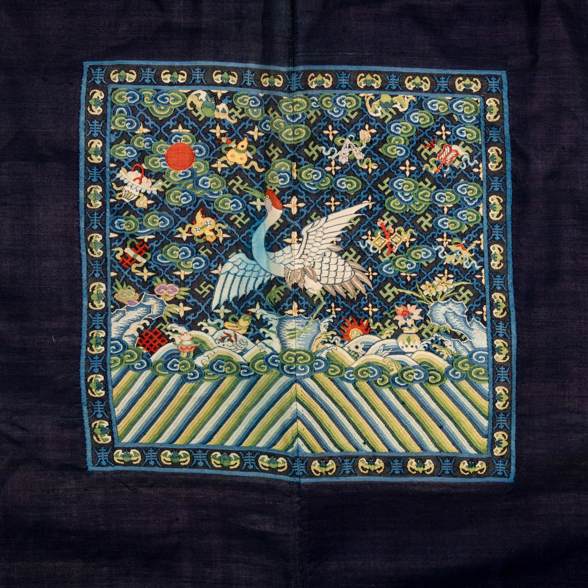 A Chinese Navy Blue Ground Official's Surcoat, Bufu, and A Velvet-Brimmed Winter Hat, Jiguan, 19th Century 清中晚期 藍地一品文官補服及冬吉冠一頂