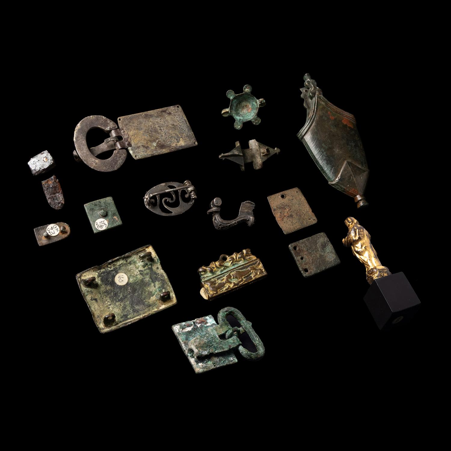 Fifteen Roman and Migration Period Fragmentary Gold, Silver, Enamel and Bronze Fibulae, Fittings, and a Chape