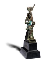 An Egyptian Bronze Isis Nursing Harpocrates