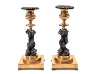A Pair of French Gilt Bronze and Ebonized Figural Candlesticks — 19TH CENTURY