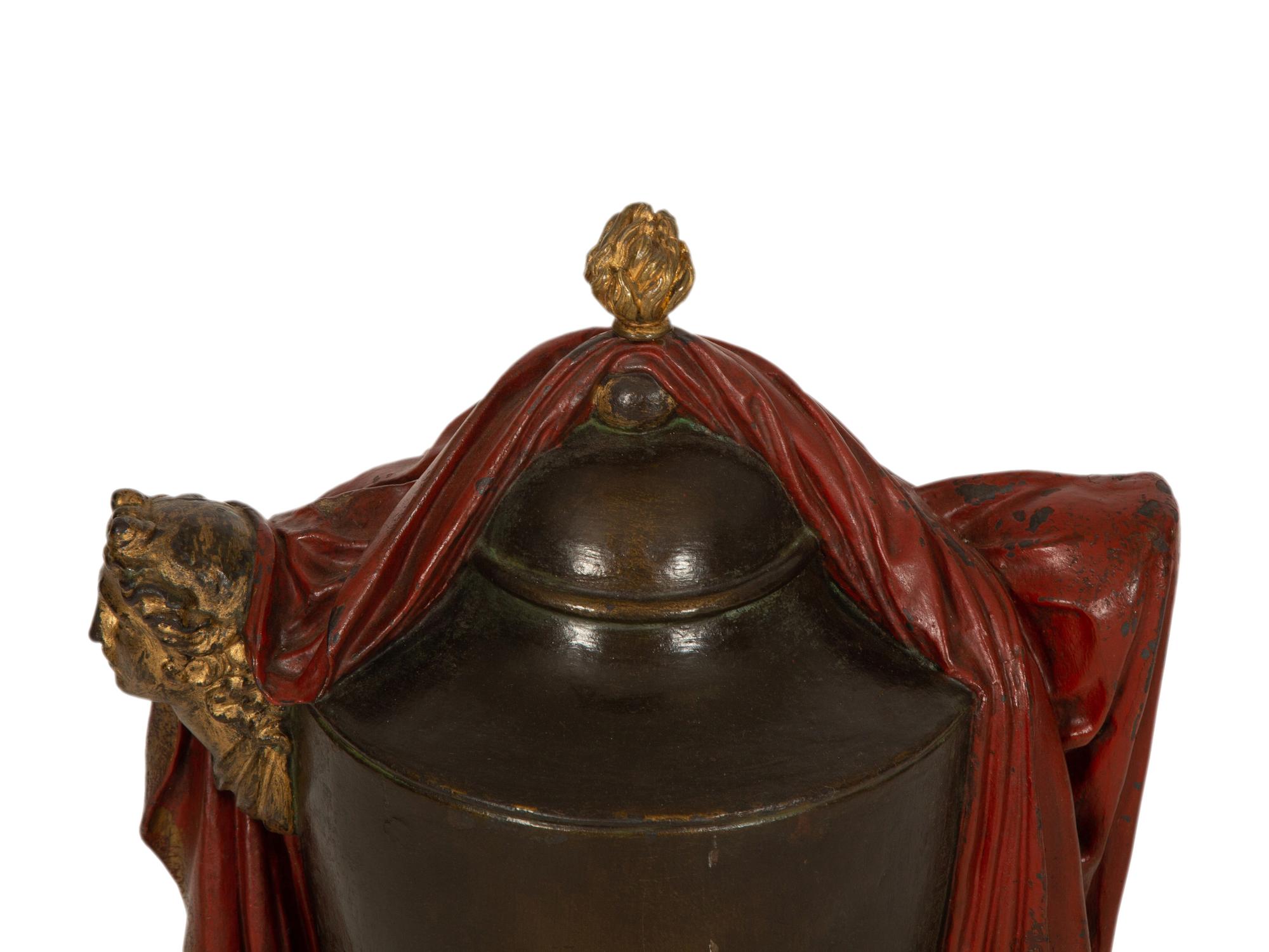A Regency Style Painted and Parcel Gilt Cast Iron Urn