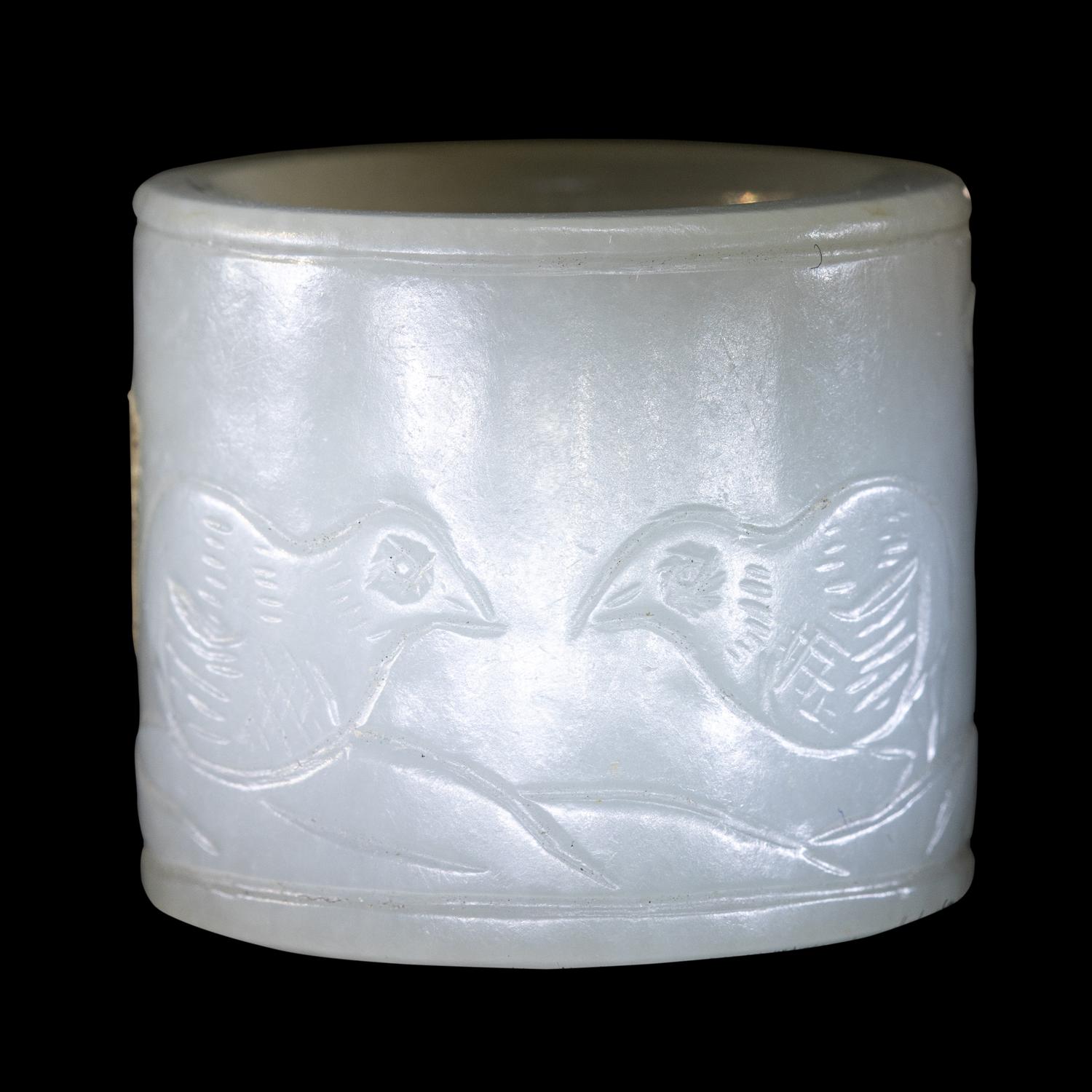A Carved White Jade 'Double Quails' Archer's Ring
