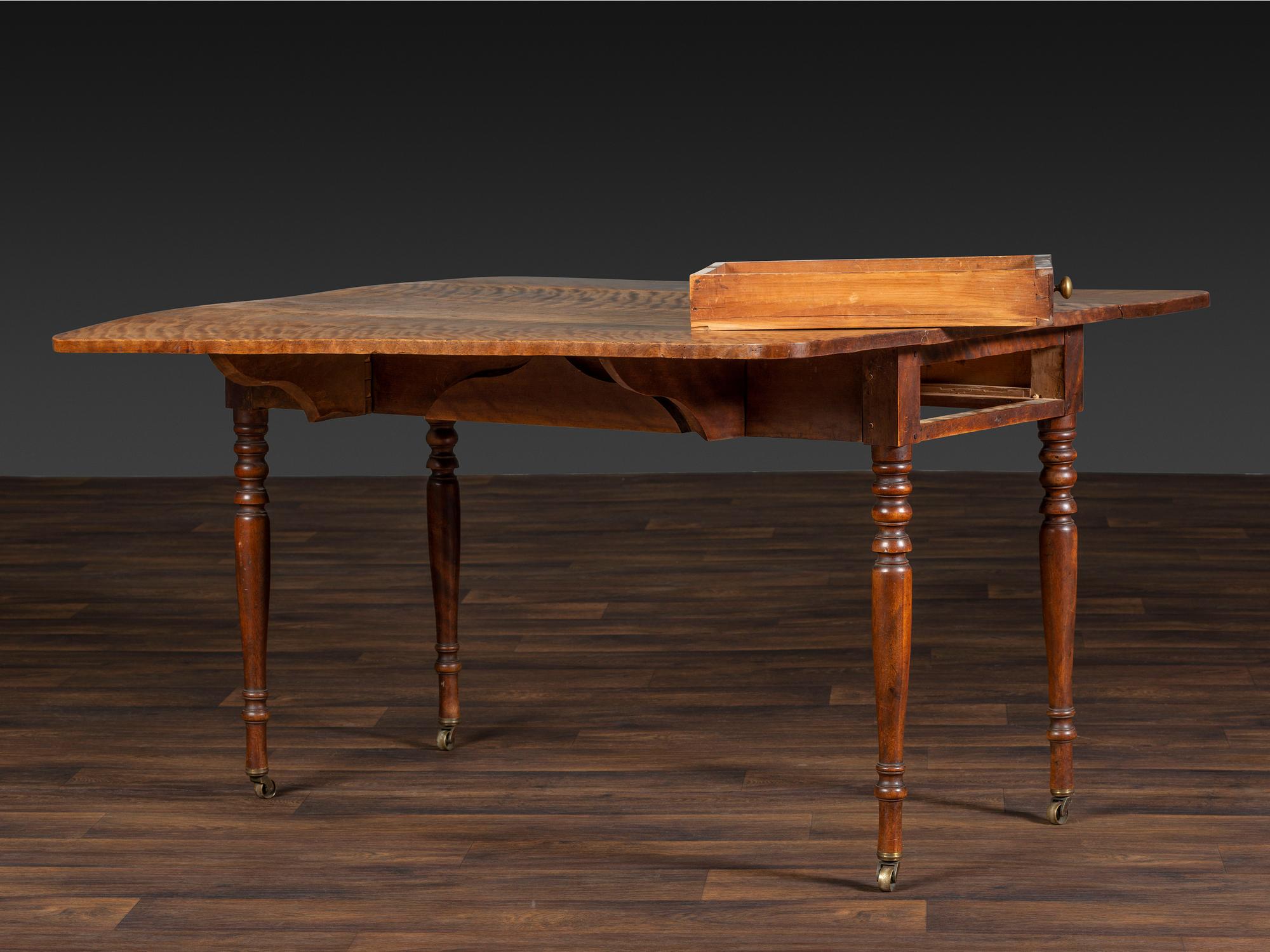 A Late Federal Figured Birch Drop Leaf Dining Table