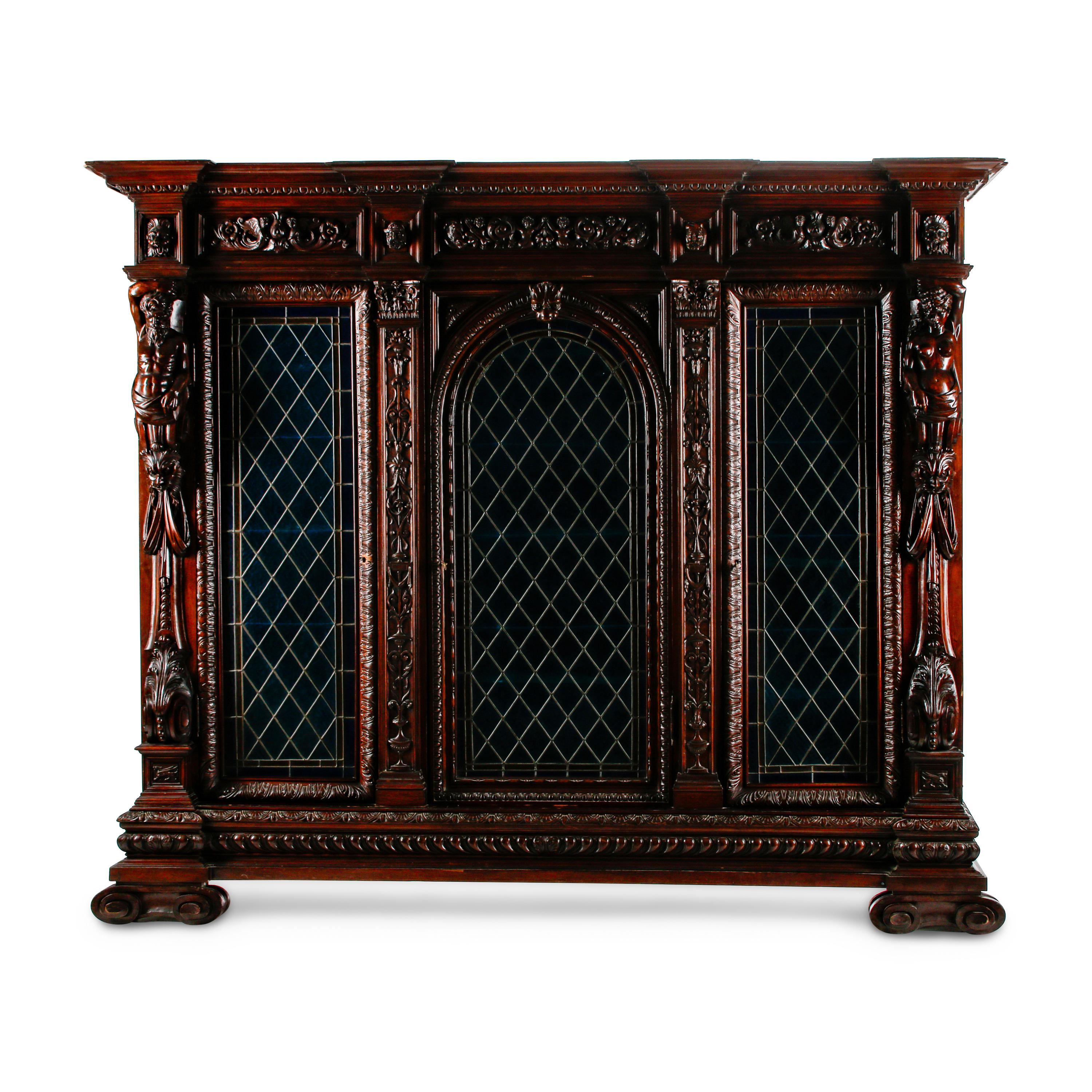 A Continental Renaissance Revival Carved Walnut and Leaded Glass Cabinet