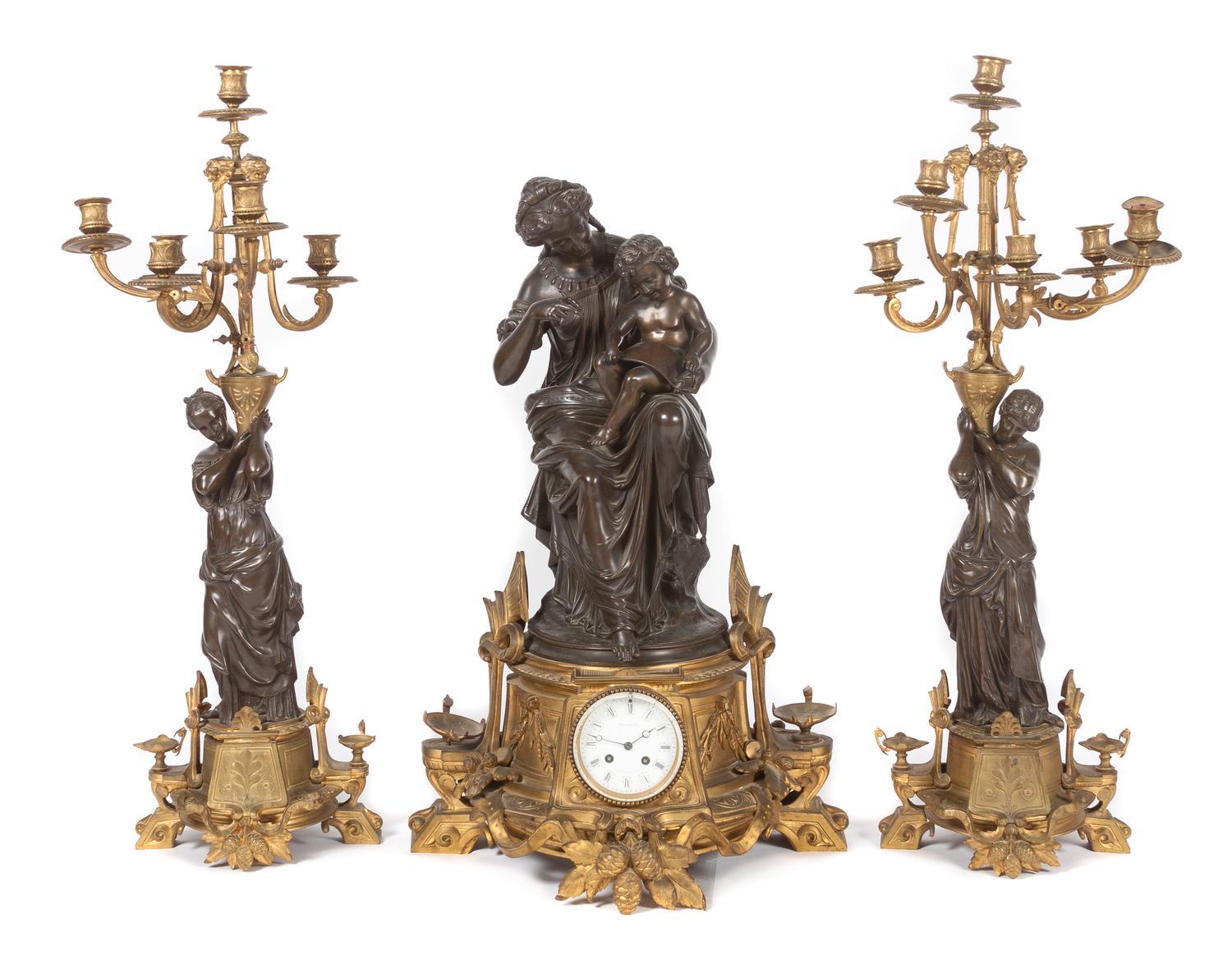 A French Three-Piece Figural Clock Garniture Height of first 28 1/2 inches. — Vauvary Fres