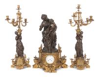 A French Three-Piece Figural Clock Garniture Height of first 28 1/2 inches. — Vauvary Fres