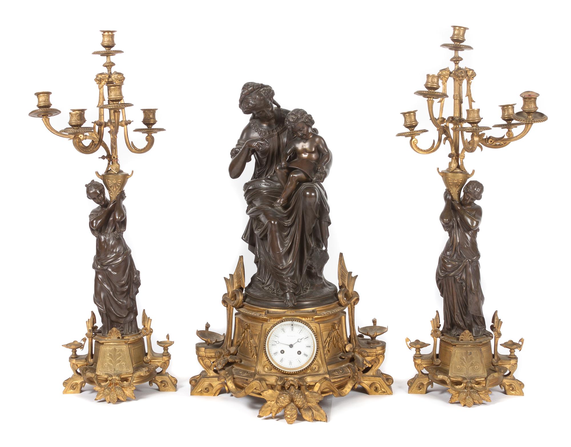 A French Three-Piece Figural Clock Garniture Height of first 28 1/2 inches. — Vauvary Fres